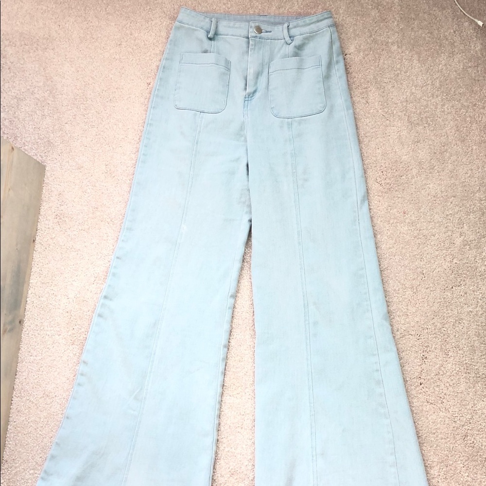 Flying tomato woman’s white washed bellbottoms